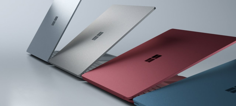 Platinum, Graphite Gold, Burgundy and Cobalt Blue Microsoft Surface Laptops Slightly Opening Up, All Angled Away to the Right